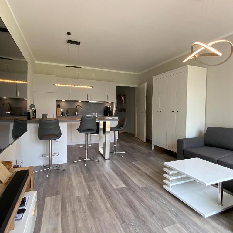 a living room with a couch and a table at Columbus in Petersdorf auf Fehmarn