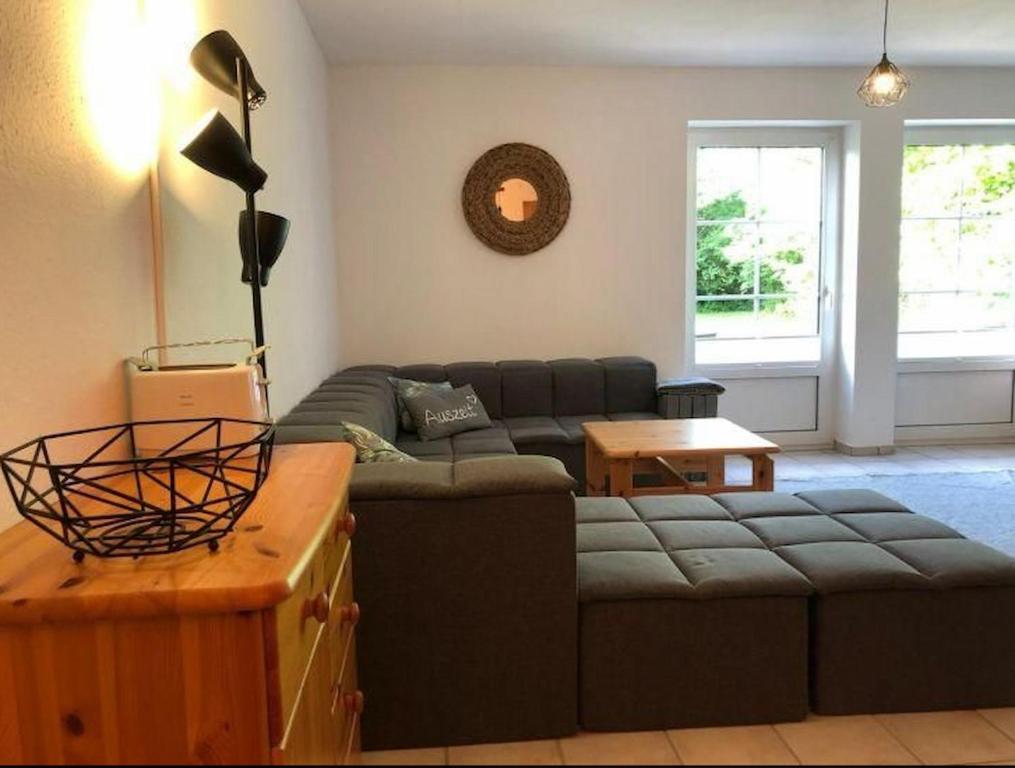 a living room with a couch and a table at Lieblingsplatz in Petersdorf auf Fehmarn