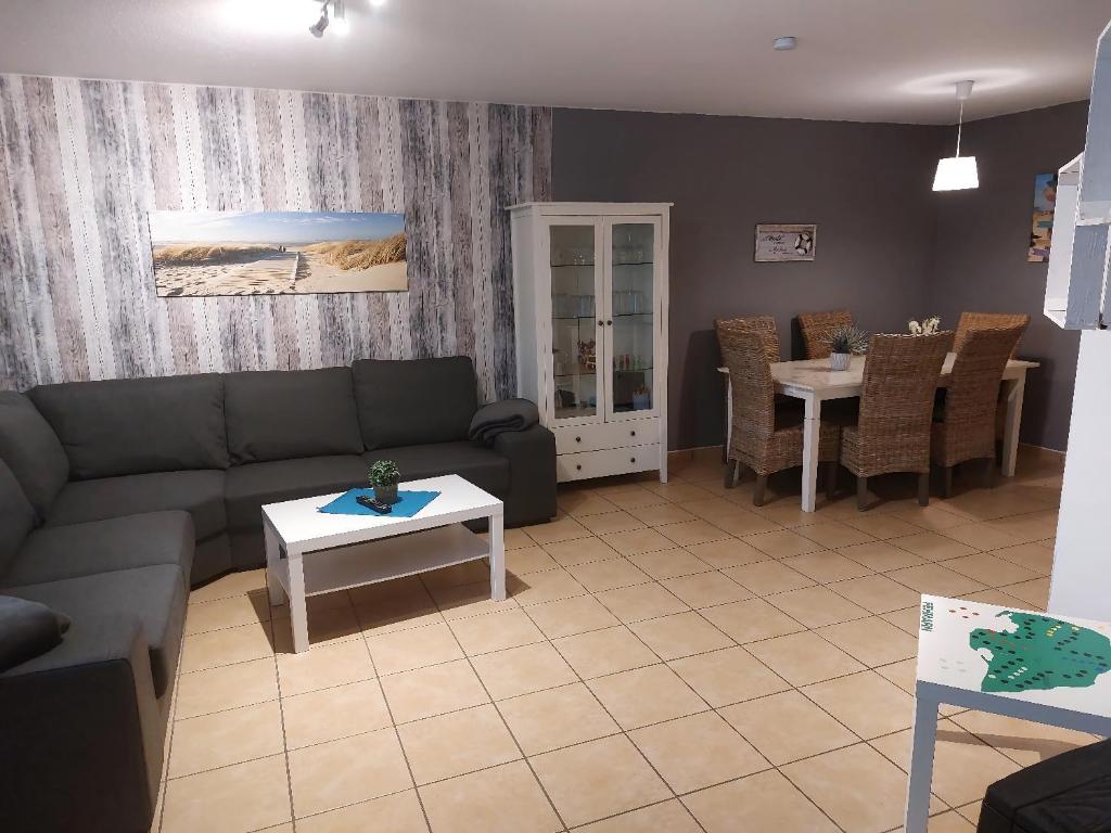 a living room with a couch and a table at Auszeit in Wenkendorf auf Fehmarn