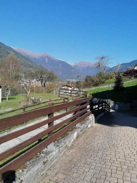 a wooden fence with a view of a mountain at MountainHome Garage and Free Parking in Bocenago