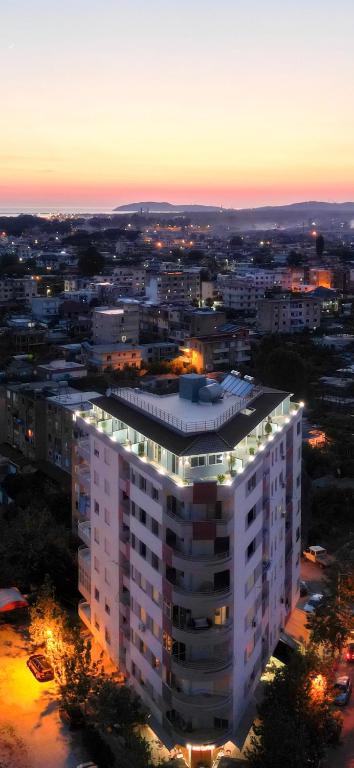 a large white building with lights on top of it at Queen Apartmets Vlore in Vlorë