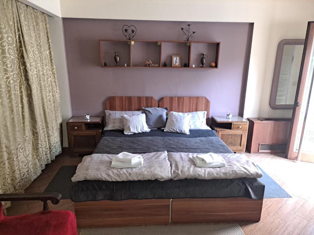 a bedroom with a bed with two towels on it at Apartment Danubius in Belgrade