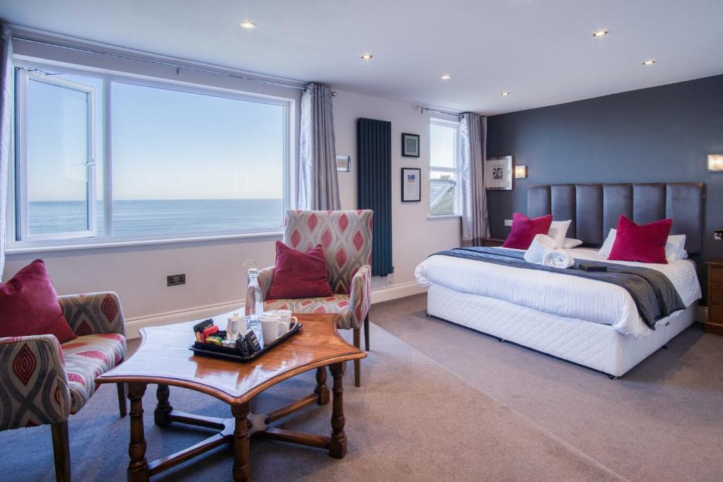 a bedroom with a bed and a large window at The Helaina in Scarborough