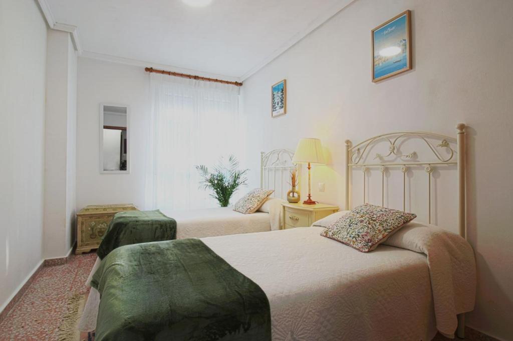 a bedroom with two beds in a room at La Luz de La Concha in Suances