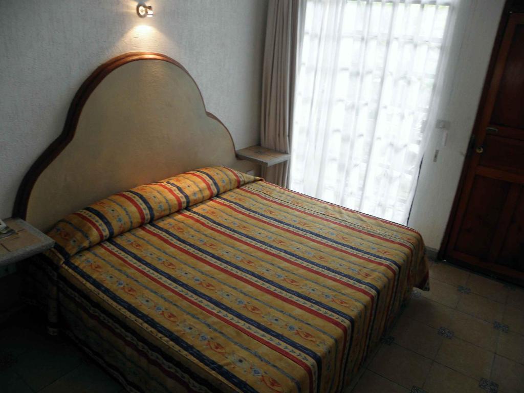 Postel nebo postele na pokoji v ubytování Hotel Fenix