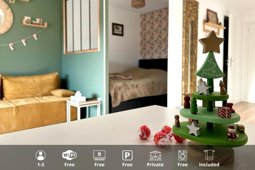 a toy christmas tree on a table in a room at La Poulie - Apartment with Balcony and Free Privative Parking - Close to Colmar in Sainte-Croix-en-Plaine