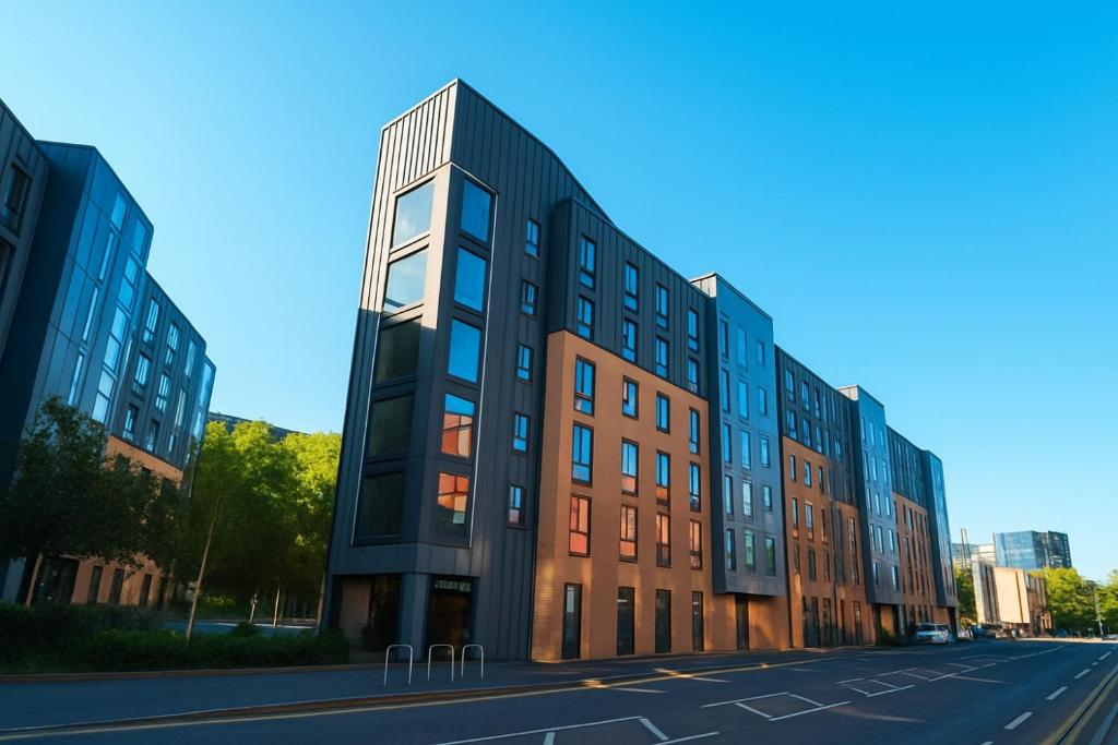 a building on a street next to a road at Dunham Halls Manchester Met in Manchester