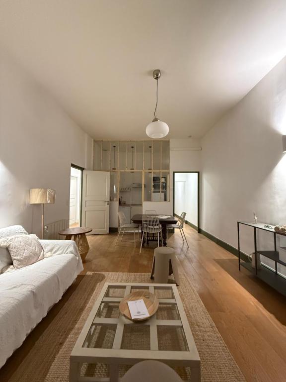 ein Wohnzimmer mit einem Bett und einem Tisch in der Unterkunft appartement lumineux cosy 4 couchages coeur de narbonne in Narbonne