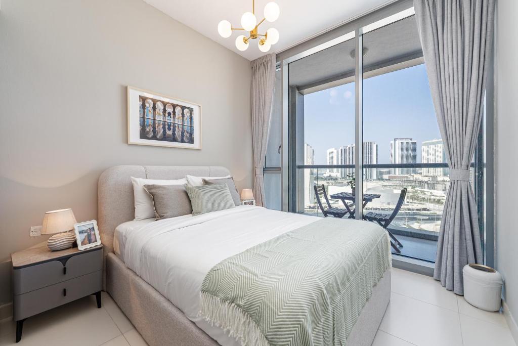 a bedroom with a bed and a large window at Urban Chic - Shams Meera in Abu Dhabi