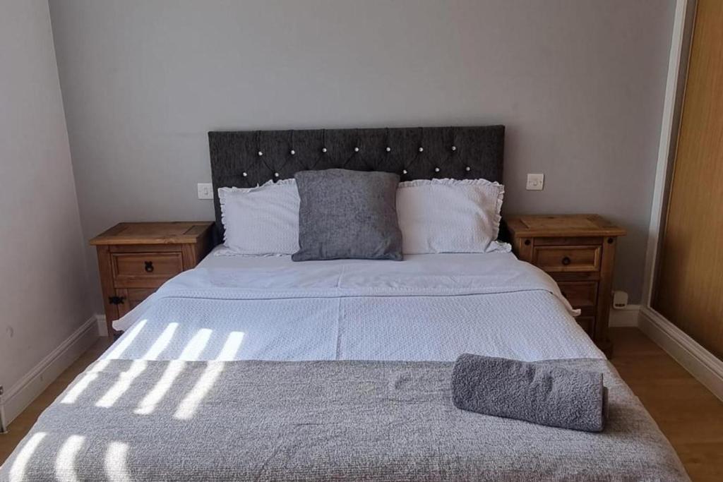 a bedroom with a large bed and two night stands at Doncaster Dream House Retreat- Sleeps 9 in Doncaster