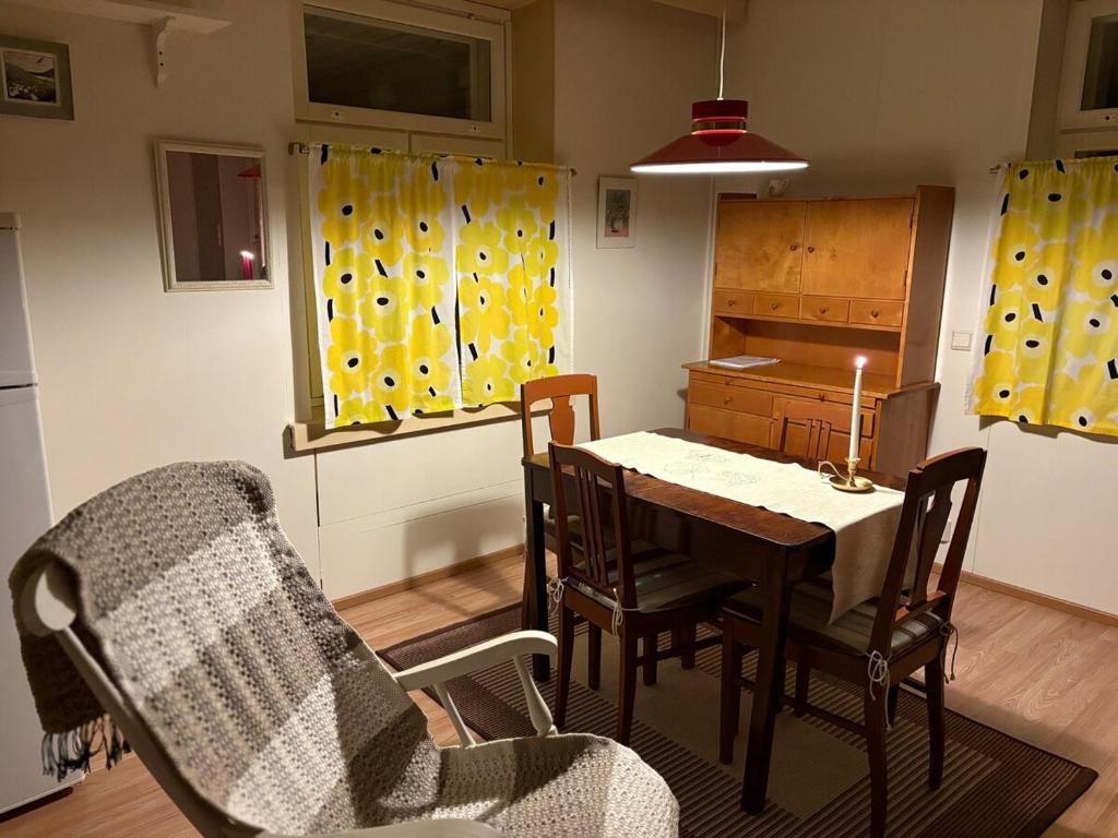 a kitchen and dining room with a table and chairs at 60m2 studio w sauna in a semi-detached house in Lapinkangas in Oulu