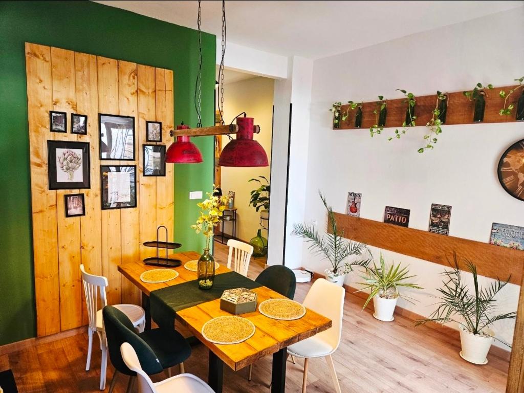 a dining room with a wooden table and chairs at Loft Home Torremirador a 40min Sevilla y Doñana in Villalba del Alcor