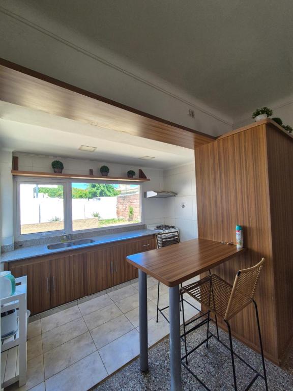 a kitchen with a wooden table and chairs at Las Gonzalez in Olavarría