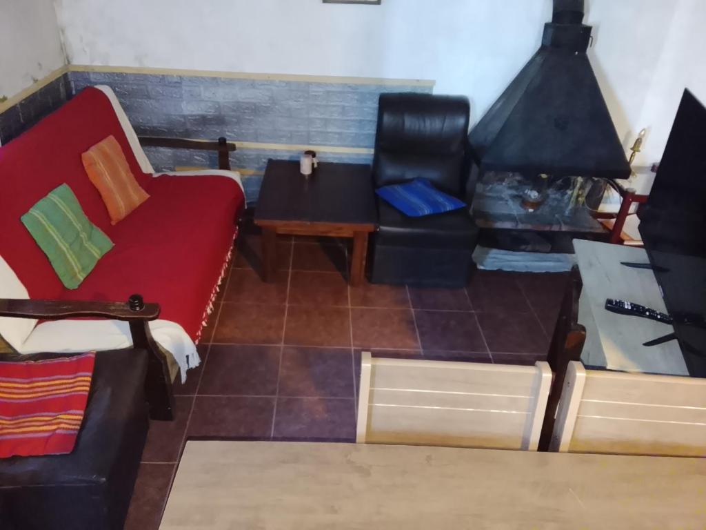 a living room with a couch and a table at Alojamiento Neres in Salto