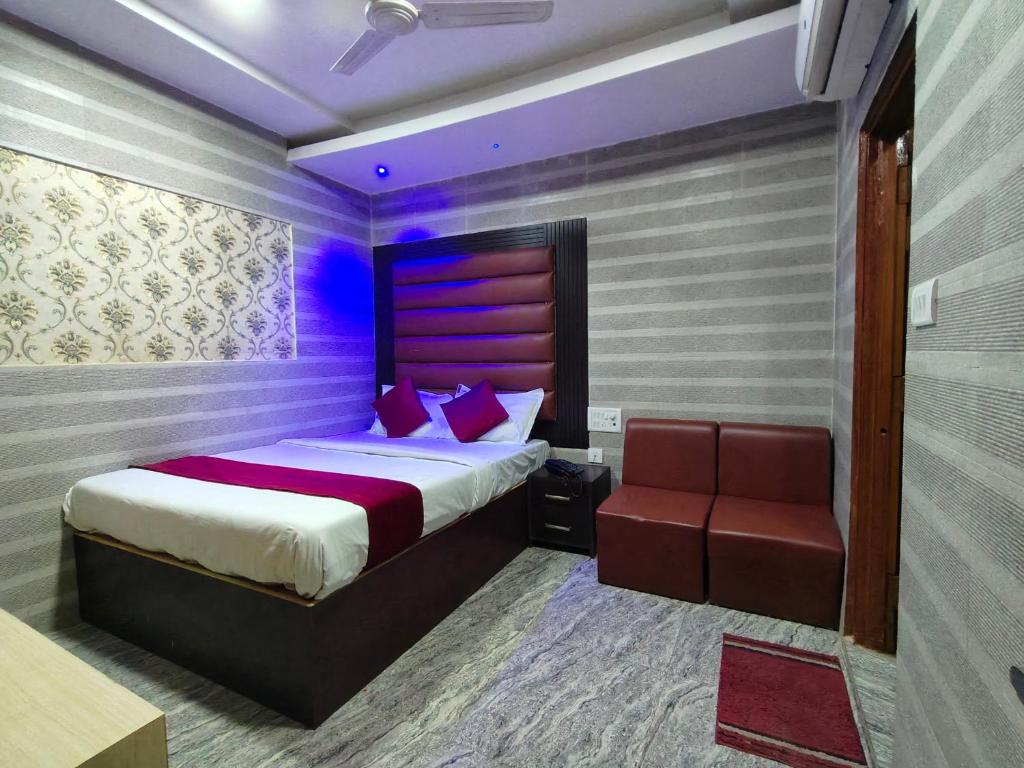a bedroom with a bed and a chair at Hotel Shimla Inn in Lucknow
