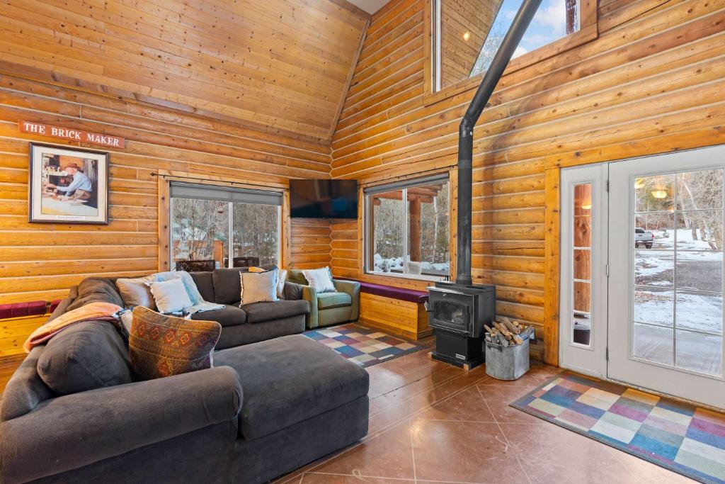 a living room with a couch and a stove at Evy's Family Ranch Cabin Secluded in Heber City