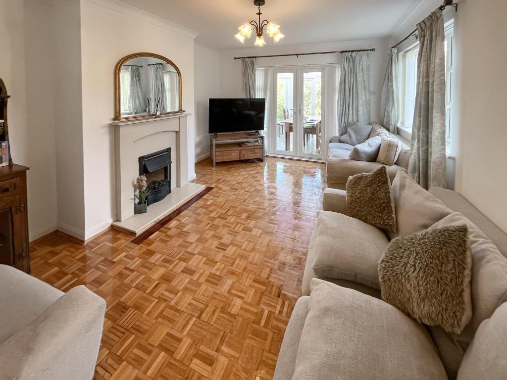 a living room with a couch and a fireplace at Springfield Bungalow in Cliftonville