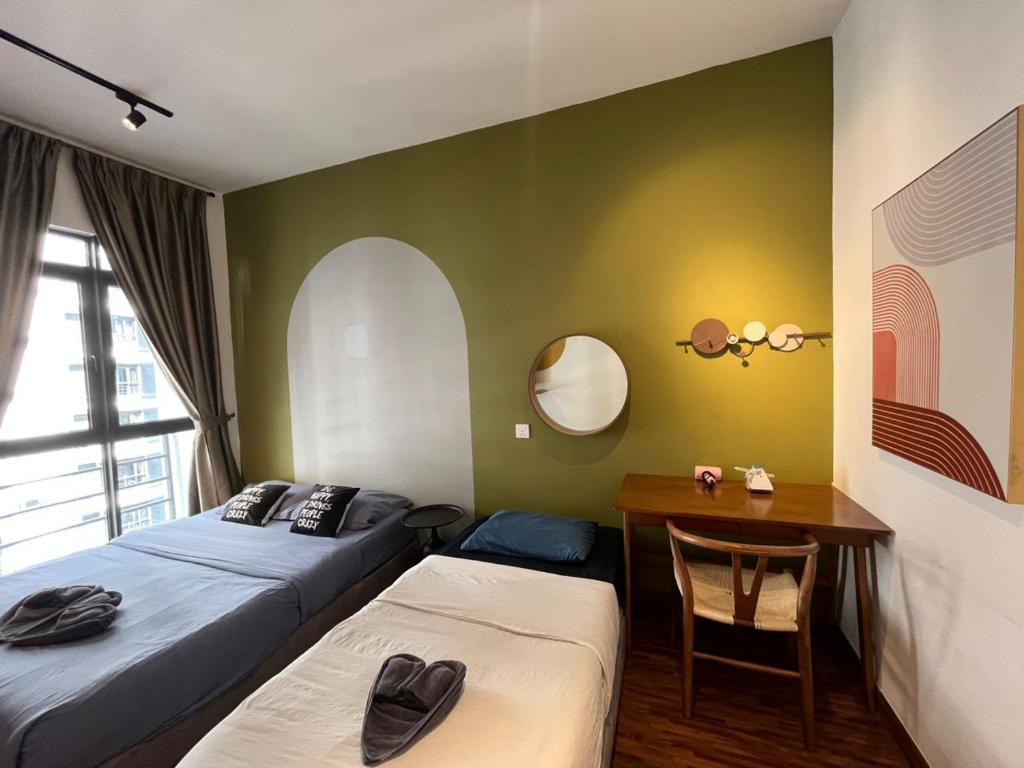 a bedroom with two beds and a desk and a table at K avenue Studio 2bed room A06 near airport by GC in Donggongon