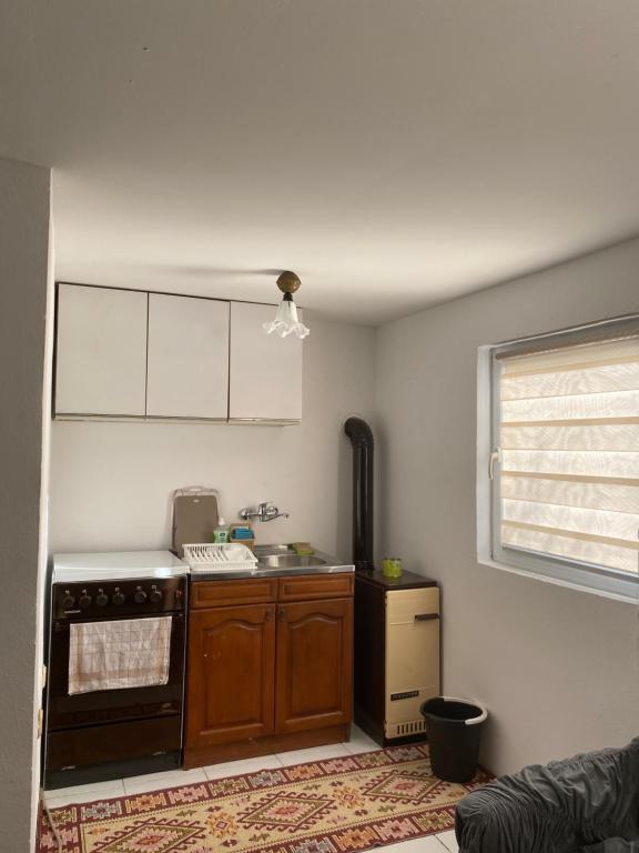 a kitchen with a stove and a sink at Vikendica- kuća za odmor in Goražde