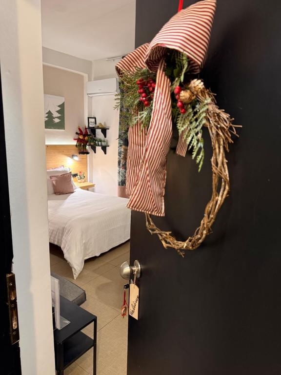 a room with a door with a christmas wreath on it at Tiny Square in Nafpaktos