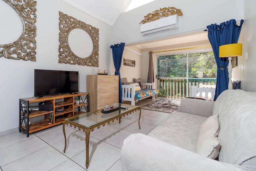 a living room with a couch and a television at The Bridge, Apartment 67 in St Lucia