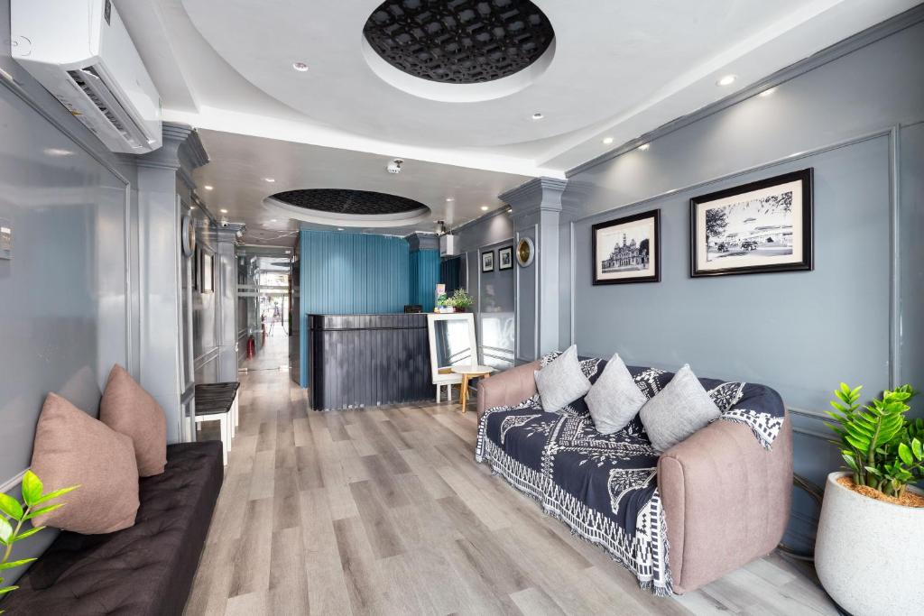 a living room with a couch and a table at Boutique Passion Hotel in Ho Chi Minh City