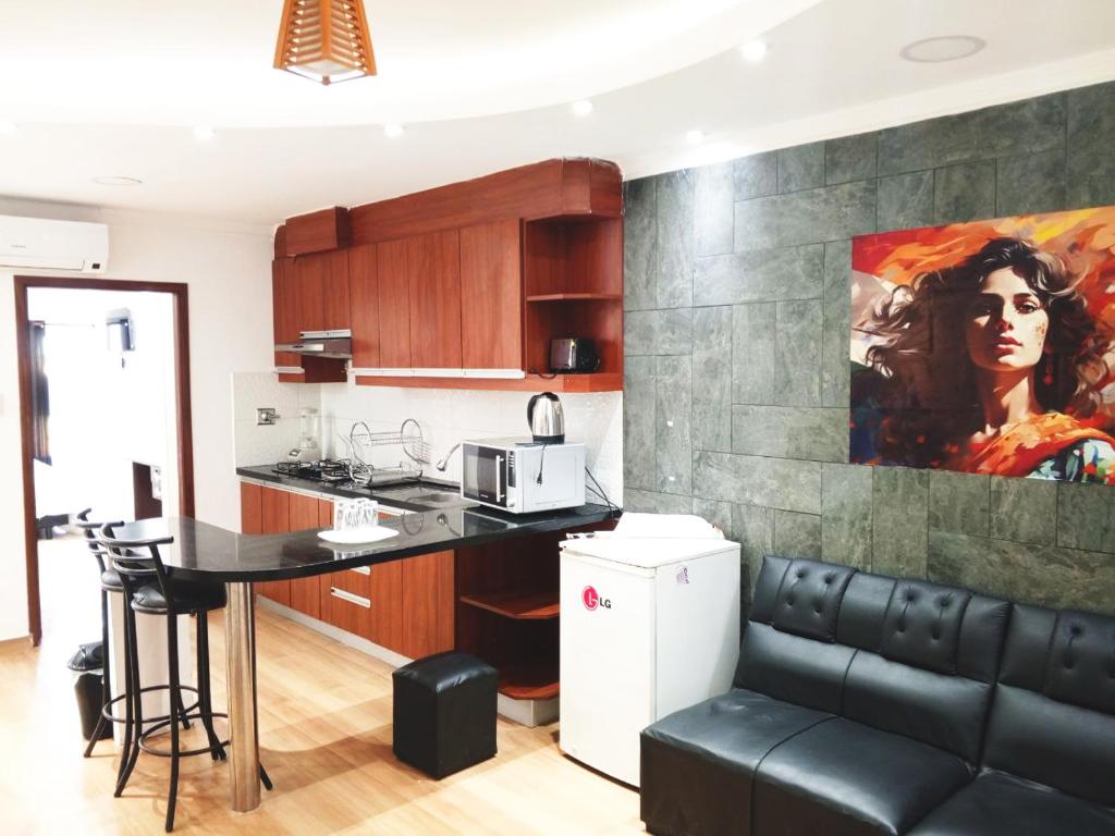 a kitchen with a couch and a table in a room at Hotel Adulam in Santa Cruz de la Sierra