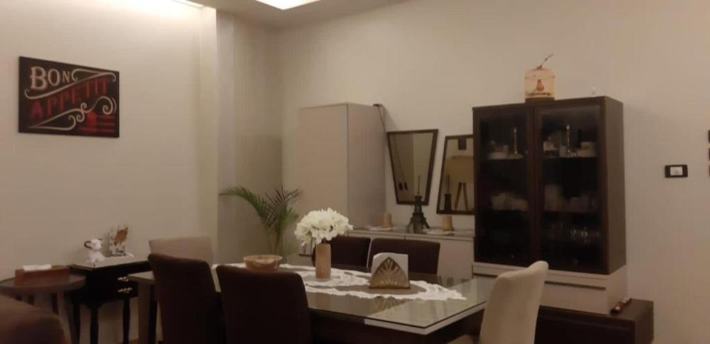 a dining room with a table and chairs and a mirror at شقة مفروشة سوبر لوكس علي النيل in Mansoura