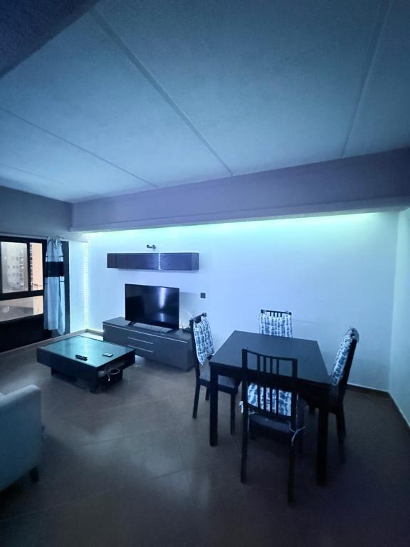 a living room with a table and chairs and a couch at 2 Bedroom City Centre Gibraltar in Gibraltar