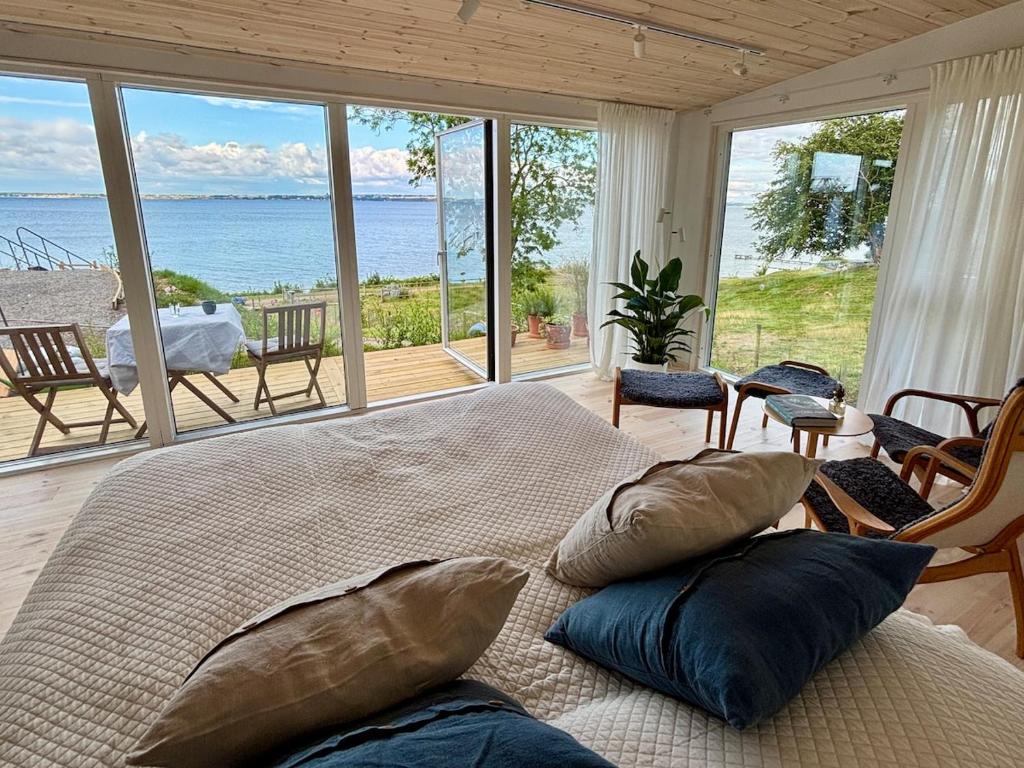 a bedroom with a bed and a view of the ocean at Gåsviken - Hven in Sankt Ibb