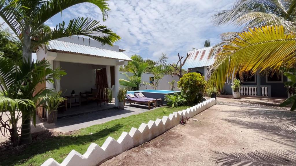 a villa with a swimming pool and a house at Tropical Paje Home with Pool Near the Beach in Paje