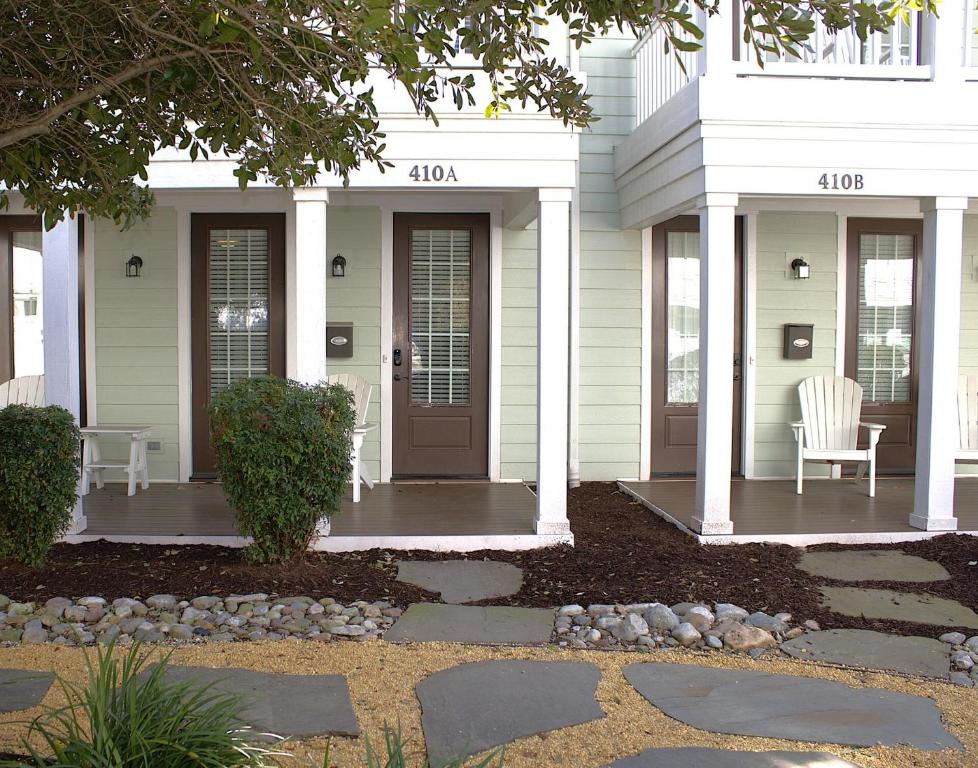 a house with a front porch with two chairs at 410B The King Neptune House in Virginia Beach