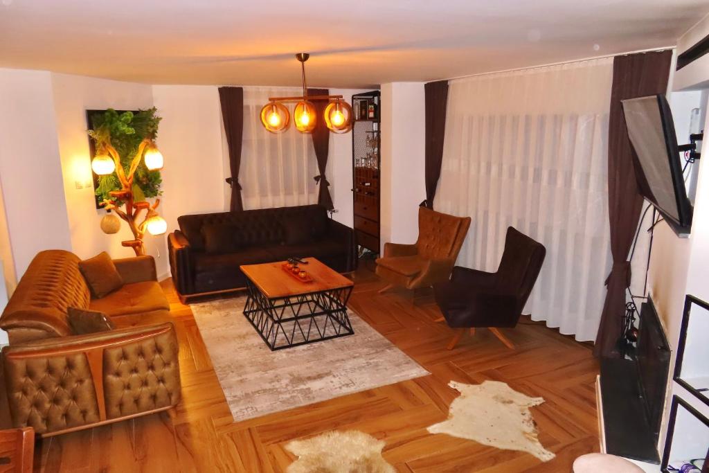 a living room with a couch and a table at Chez Vila in Prizren