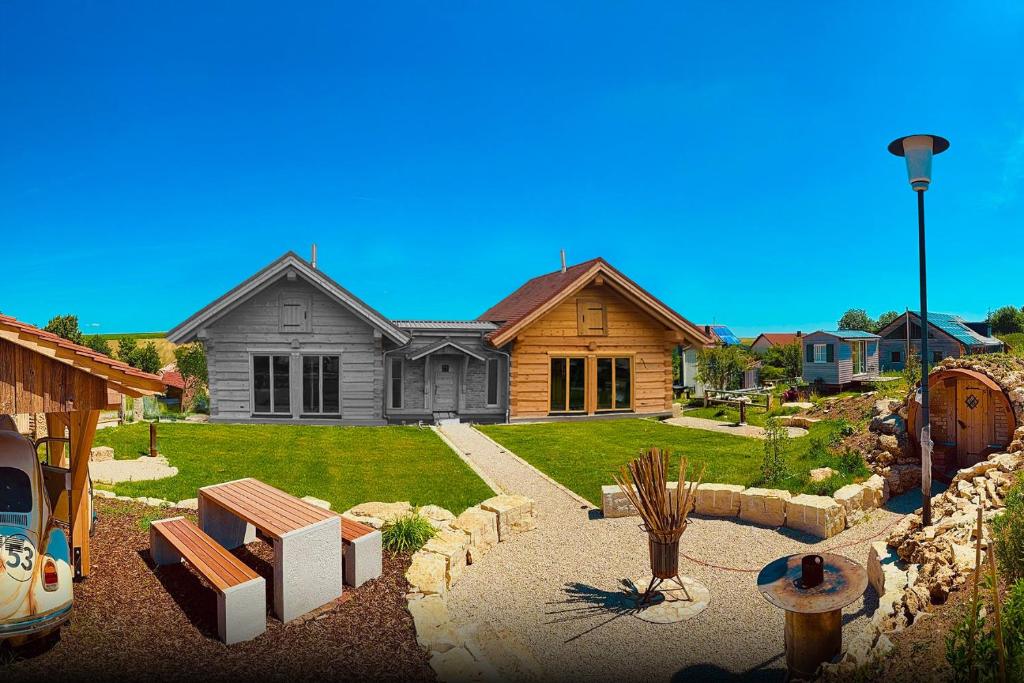 a house with a landscaping in front of it at Chalets Waldeck - Urlaub im Fränkischen Seenland 