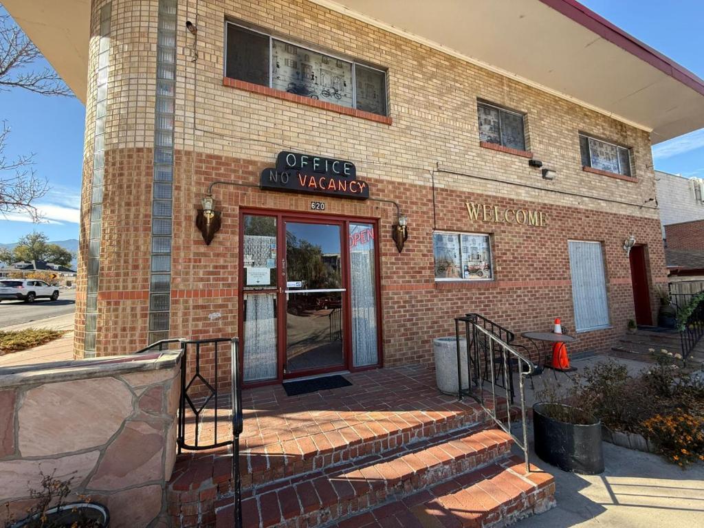 a brick building with the entrance to a wine shop at Springs Inn by Capital O I 25 in Colorado Springs