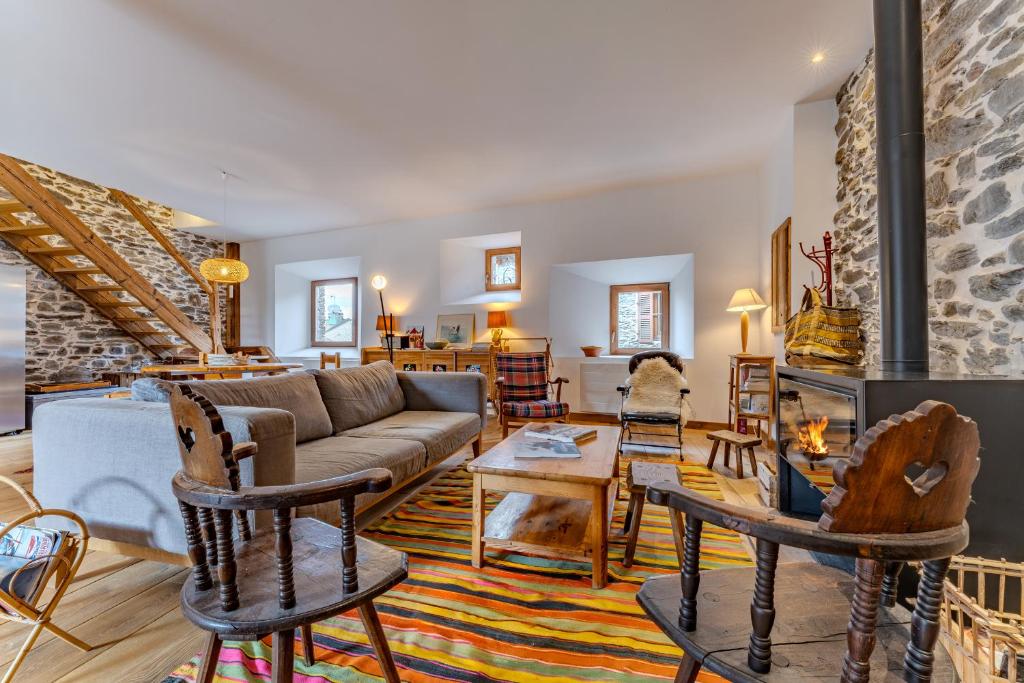 a living room with a couch and chairs at Chalet des Granges in Saint-Marcel
