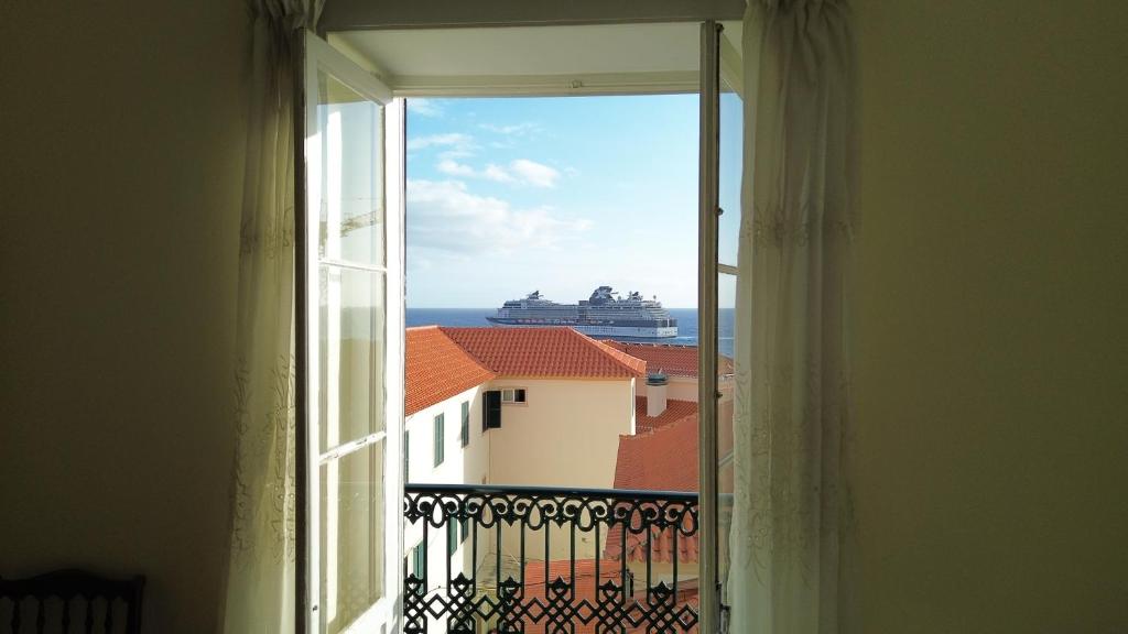 a view of a cruise ship from a window at Mirasol Guesthouse in Funchal