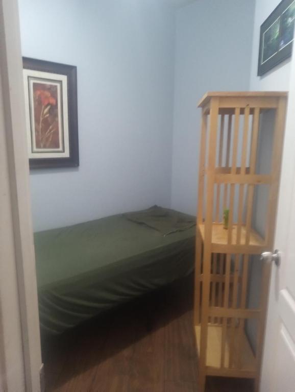 a bedroom with a bed and a book shelf at Westgate Tiny Room 94th in Phoenix