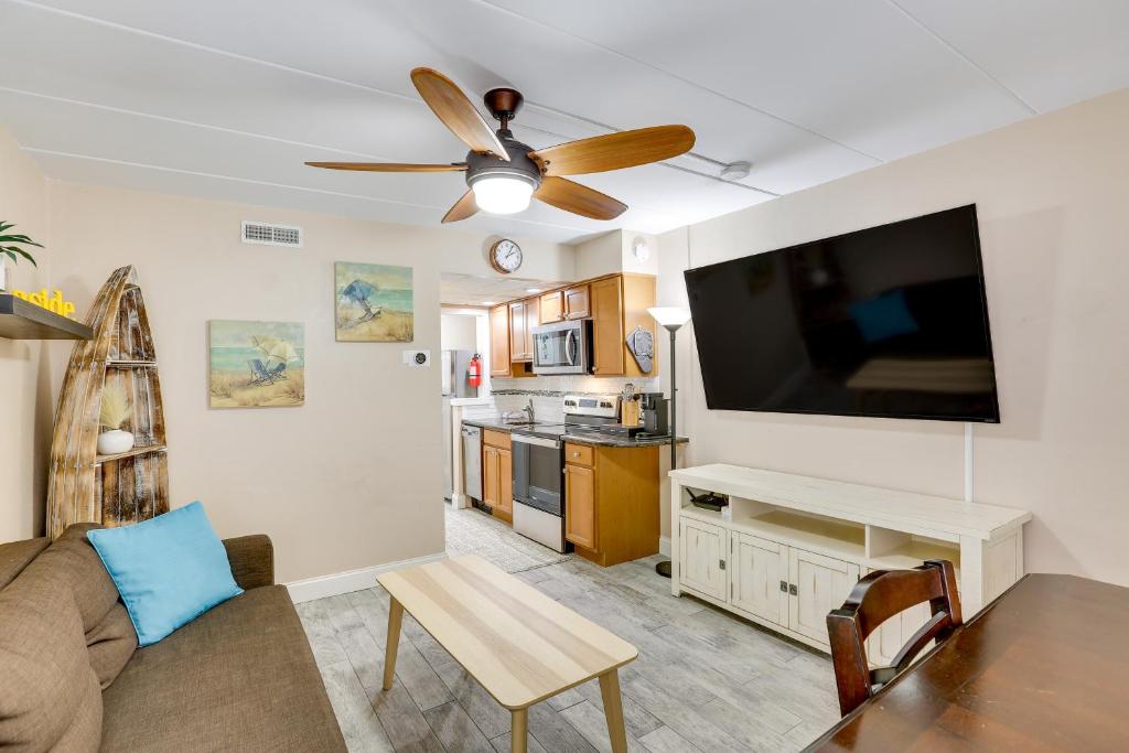 a living room with a couch and a flat screen tv at Wildwood Condo with Community Pool Walk to Beach! in Wildwood