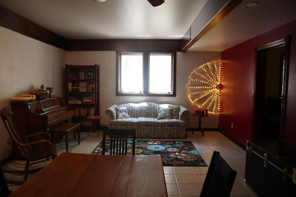 a living room with a couch and a table at Cirque Stay in Lawrence