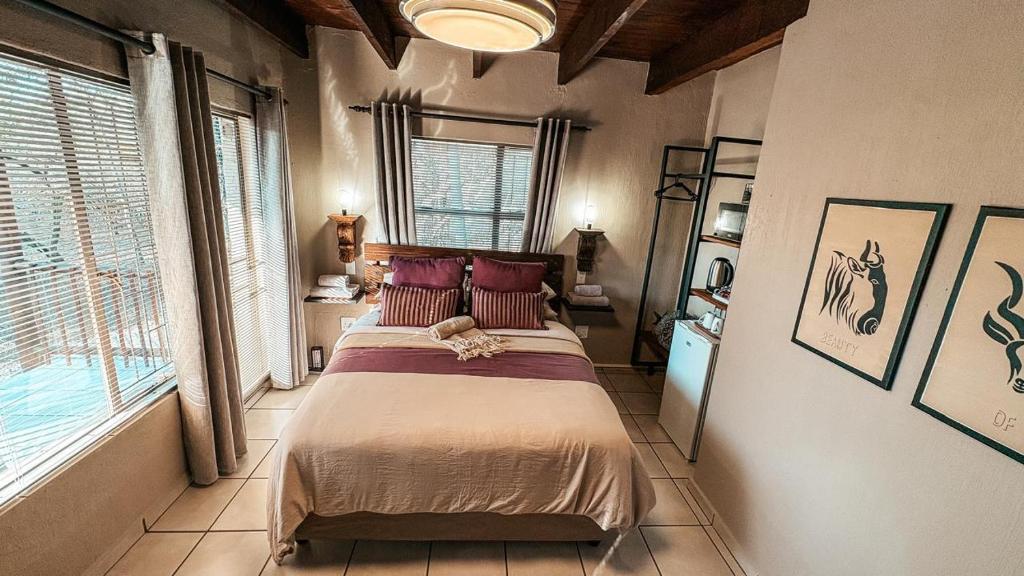 En eller flere senge i et værelse på Figtree Escape