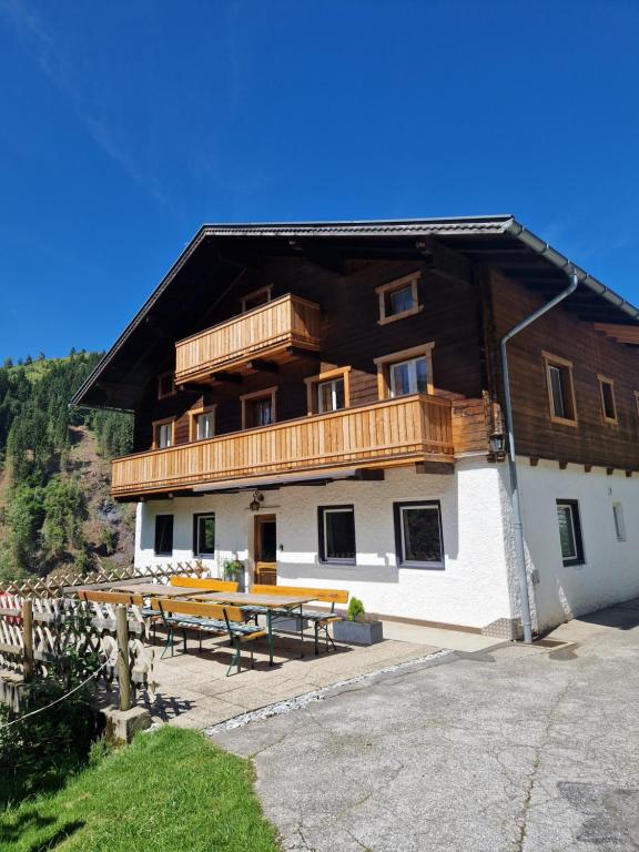 a large building with a picnic table in front of it at Almhof Grub in Wagrain