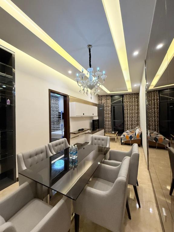 a dining room with a glass table and chairs at Dorsett Residences Executive KL in Kuala Lumpur