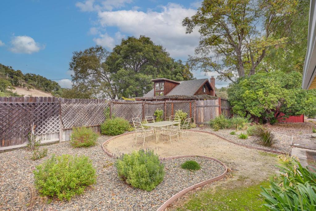 a garden with a table and a fence at 2 Mi to Dtwn Atascadero! Cozy Cottage with Yard in Atascadero