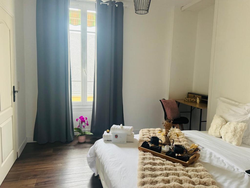 a bedroom with a bed with blue curtains at DAMA Lodge in La Ferté-Bernard