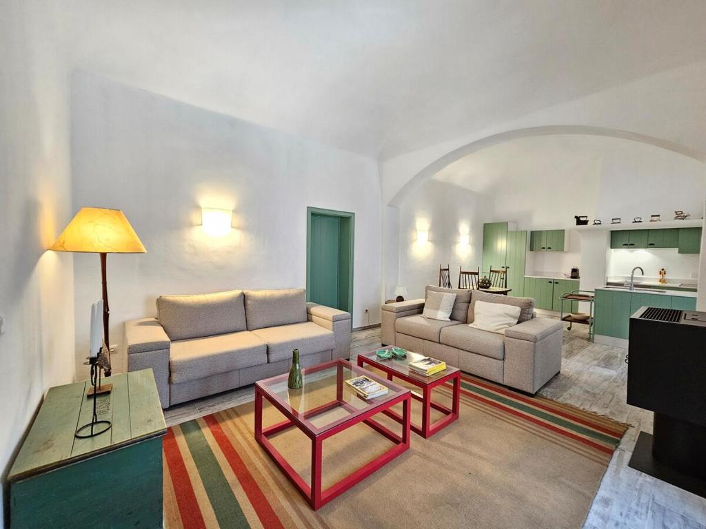 a living room with two couches and a table at Casa Tradicional in Évora