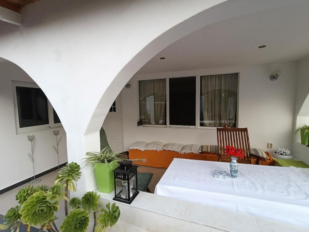 a living room with a table and a couch at Irini Garden House in Vathí