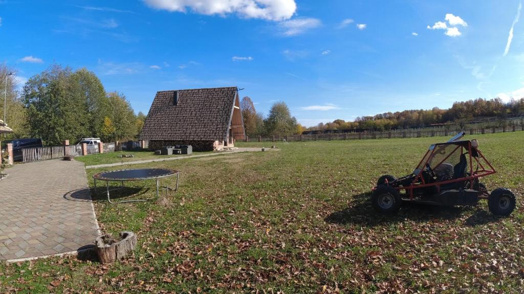 a tractor parked in a field next to a barn at Red Brick 