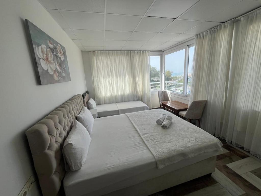 a hotel room with a bed and a window at Marin Apart Arsuz in Arsuz