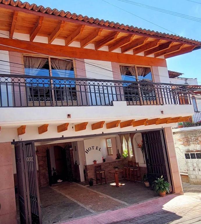 an outside view of a house with a balcony at Hotel Johanan in Valle de Bravo